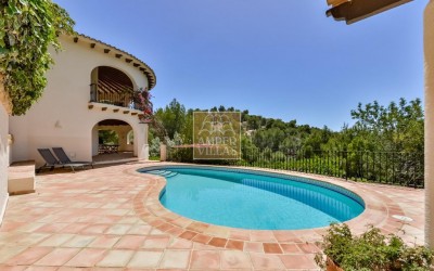 A beautiful villa in a peaceful, green setting.