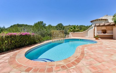 A beautiful villa in a peaceful, green setting.