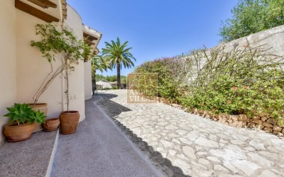 A beautiful villa in a peaceful, green setting.